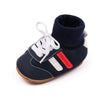 Navy blue baby booties with white laces and anti-slip soles
