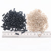 A collection of black and beige plastic safety eyes for amigurumi, including small screws and locking washers.