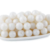 A pile of small, round, translucent white silicone beads for jewelry making and crafting.