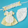 A vintage lace maid dress set for dolls featuring a yellow dress and a matching white bonnet with a ribbon.