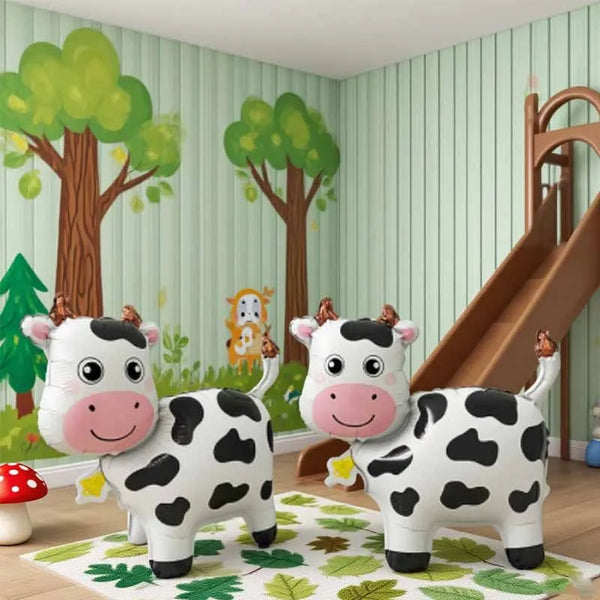 A set of three 3D cartoon cow balloon decorations featuring black and white spotted cows in a green room setting.