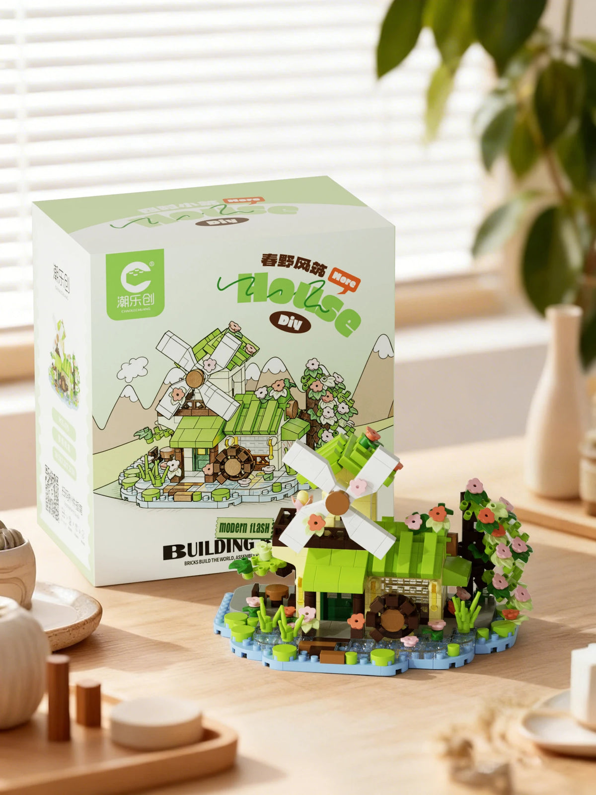 A box of Forest Cabin micro building blocks set featuring a greenhouse and windmill model.
