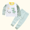 A white long sleeve shirt and matching striped pants set for a child, featuring a dinosaur graphic.