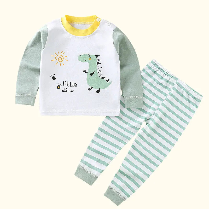 A white long sleeve shirt and matching striped pants set for a child, featuring a dinosaur graphic.