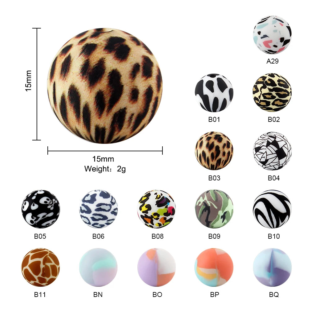 A collection of 12 printed silicone beads in various patterns including leopard, floral, and abstract designs.