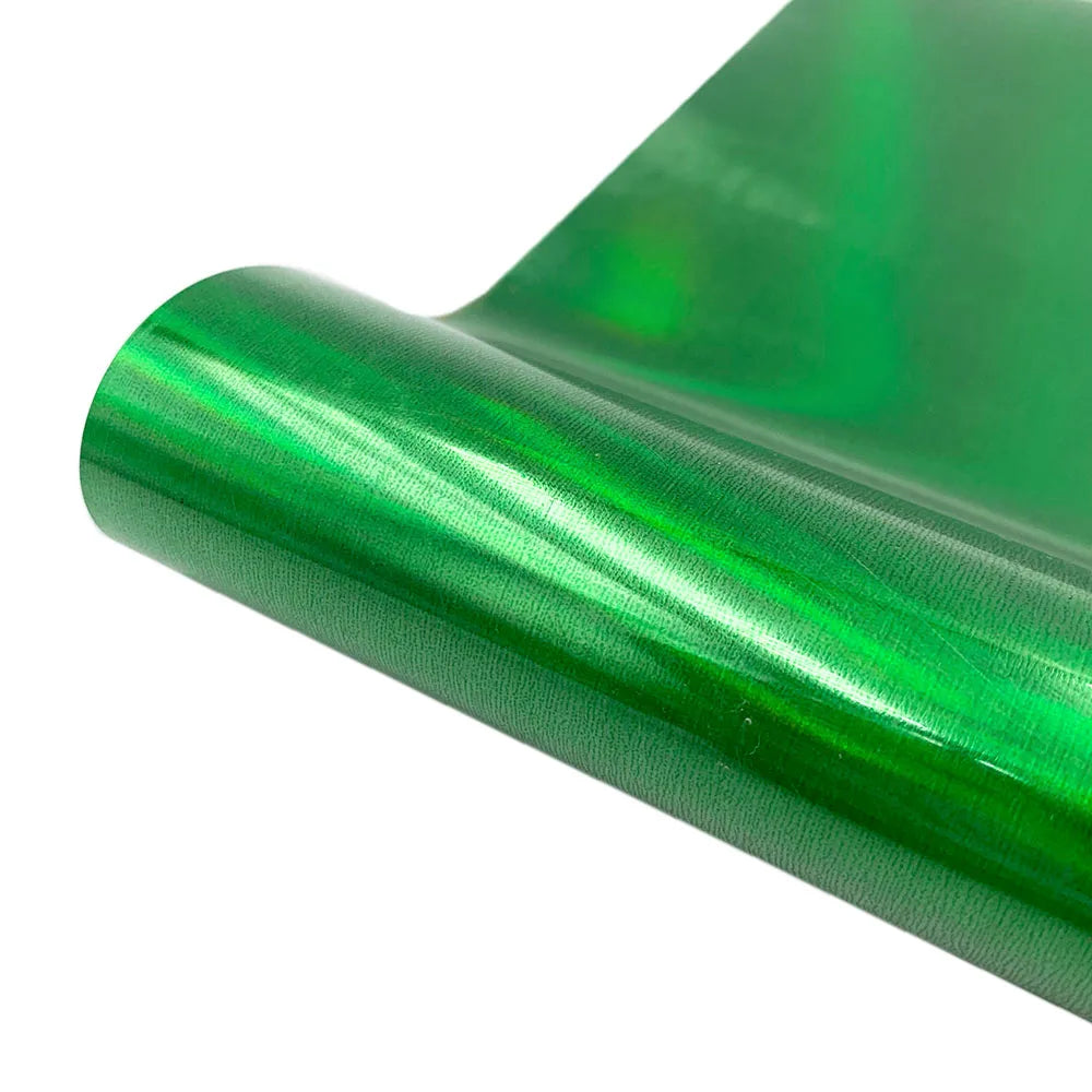 A roll of green holographic heat transfer vinyl for crafting projects.