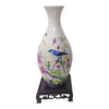 Blue and white porcelain flower vase puzzle featuring a bird design on a pedestal.