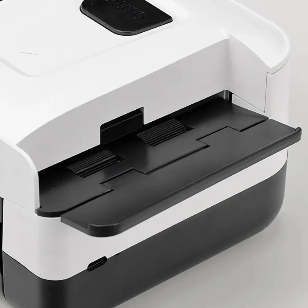 A white and black portable automatic card shuffler device with a removable tray is shown.
