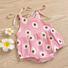 Pink cotton romper for a baby girl with a white daisy floral print and adjustable ties
