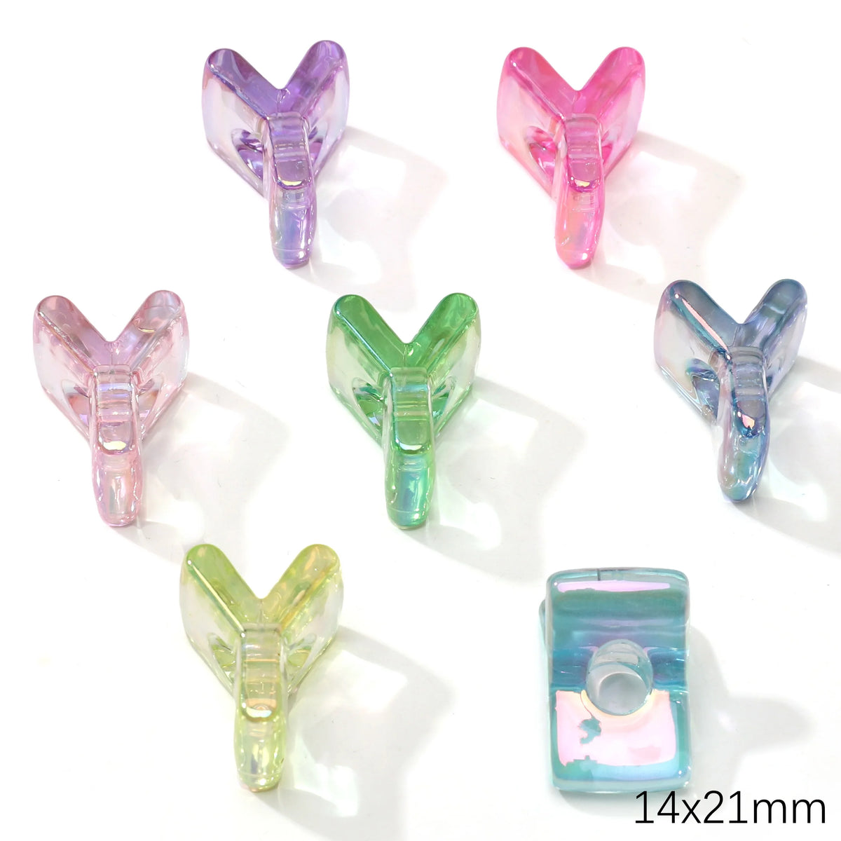 A collection of colorful acrylic alphabet beads in various shades of pink, purple, and green.