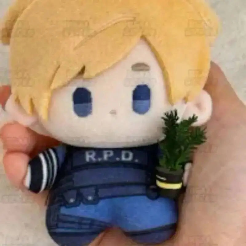 A plush doll set featuring characters with blonde hair and blue eyes, held in a person's hand.