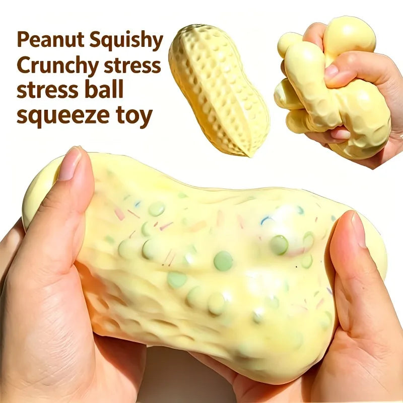 A hand holds a yellow peanut butter squishy stress ball with small colored dots on it.