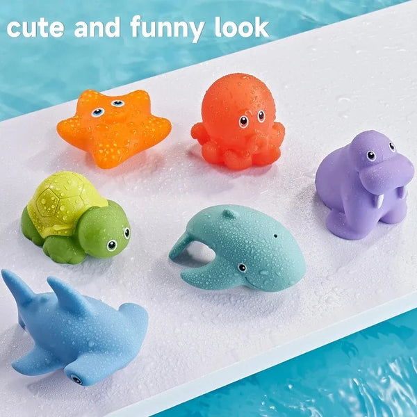 A collection of colorful, rubbery animal bath toys including an orange duck, a pink octopus, a green turtle, a blue elephant,