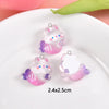 Pink and purple resin charms shaped like cute sea otters for jewelry making
