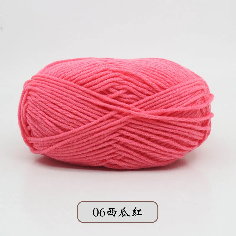 A ball of bright pink pre-dyed milk cotton yarn used for knitting and crochet.
