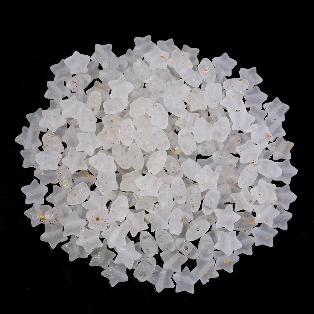 A pile of small, clear, star-shaped acrylic beads for jewelry making.