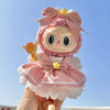 A 17cm mini doll with pink hair and a wedding dress outfit featuring a bow and a gold-colored accessory.
