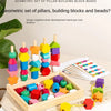 A geometric set of wooden building blocks and beads in various colors and shapes laid out on a light fabric.