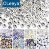A collection of sparkling crystal flatback rhinestones and various glitter embellishments for nail art and crafts.