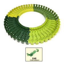 A circular puzzle made of green and yellow interlocking pieces shaped like a race track