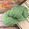 A ball of light green yarn, 300g, used for knitting or weaving projects.