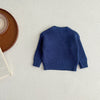 A navy blue ribbed knit baby pullover sweater lying flat on a light surface.