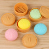 A collection of various colored squishy stress balls and containers on a wooden surface.