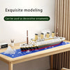 A model of the Titanic iceberg scene built from white and black building blocks displayed on a wooden table.