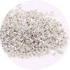 A pile of small, silver metallic glass beads for jewelry making