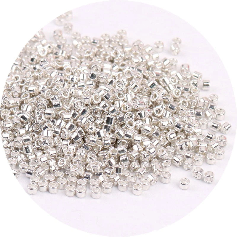 A pile of small, silver metallic glass beads for jewelry making