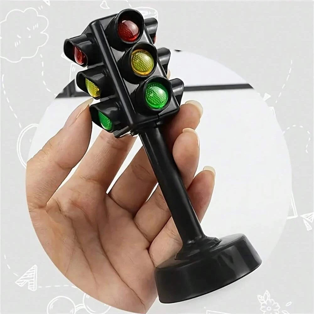 A hand holds a black mini traffic light puzzle with colored lenses, demonstrating the toy.