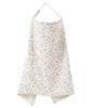 A white and floral patterned breathable muslin nursing cover with an adjustable neckline.