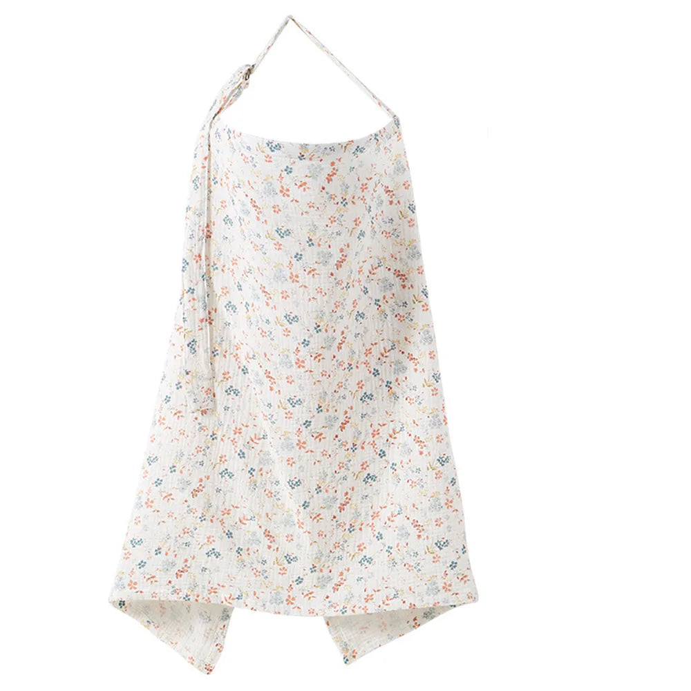 A white and floral patterned breathable muslin nursing cover with an adjustable neckline.