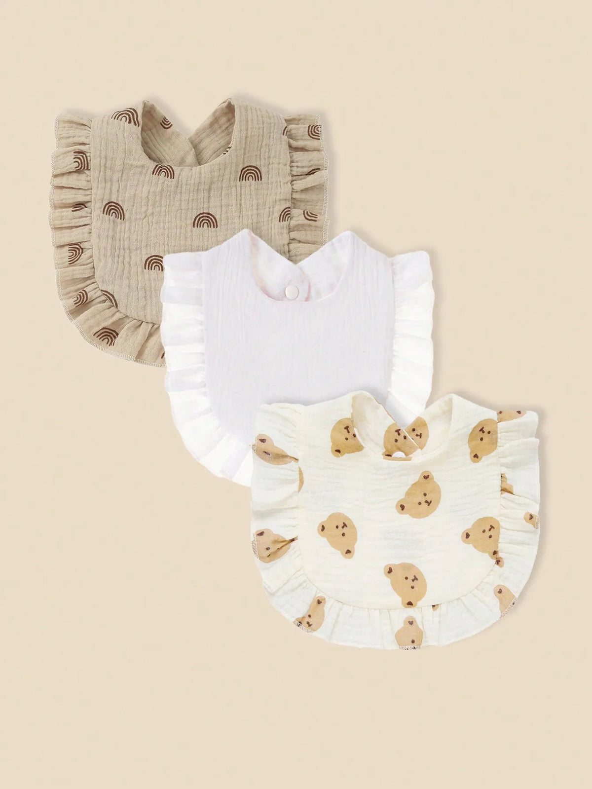 A set of three pure cotton muslin baby bibs featuring a beige striped pattern and cute animal designs.