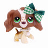 A brown miniature pet animal figure with large eyes and a green checkered bow and pearl necklace.