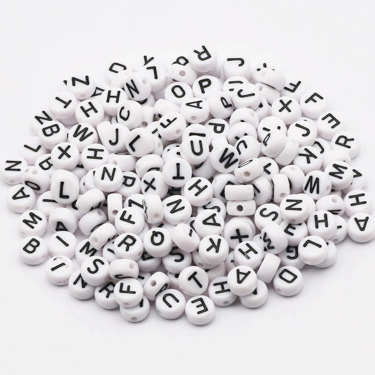 A pile of 100 round white acrylic alphabet beads for jewelry making