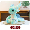 A light blue Toothless dragon plush toy with large eyes and soft features sitting on a woven mat.