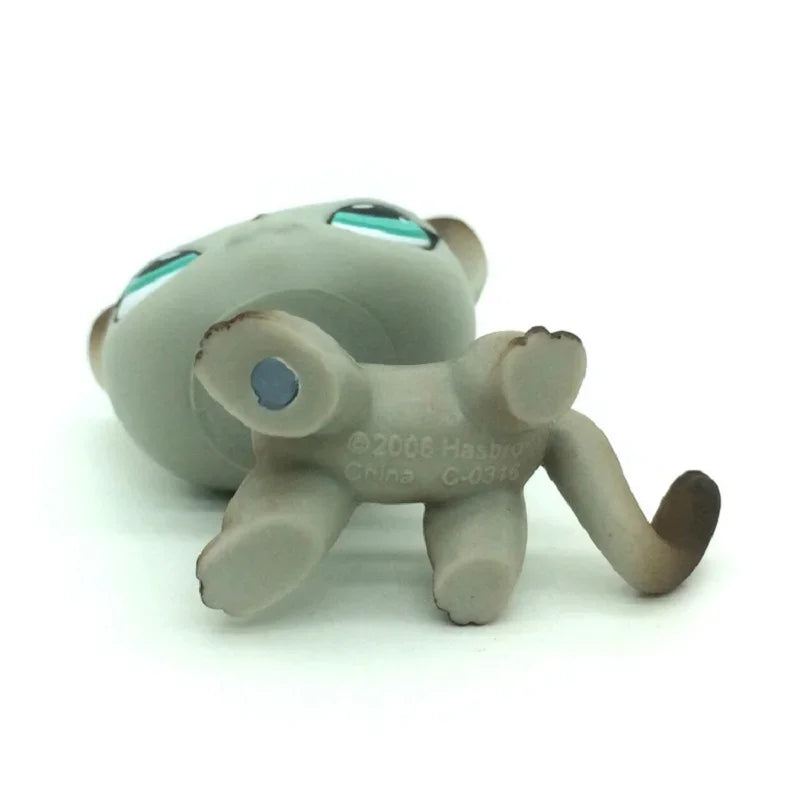 A small, gray Littlest Pet Shop style standing dog figure with blue eyes.