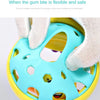 A hand is holding a light blue sensory catch ball rattle toy with yellow accents, showing its flexible and safe design.
