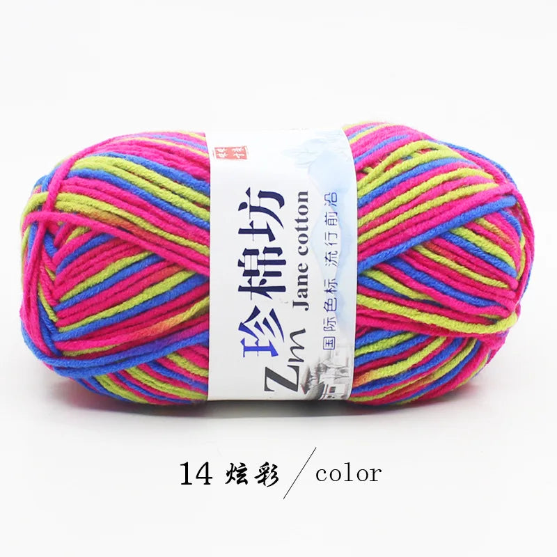 A ball of bright multi-colored yarn, including pink, yellow, green, and blue strands, packaged with a white label.