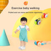 A toddler is exercising by pulling a musical pull-along snail toy for baby walking exercise.