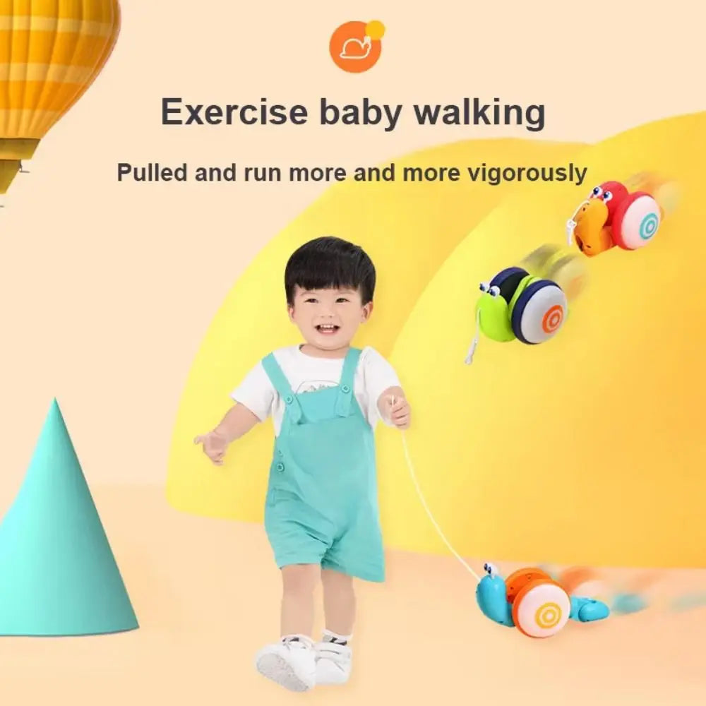 A toddler is exercising by pulling a musical pull-along snail toy for baby walking exercise.