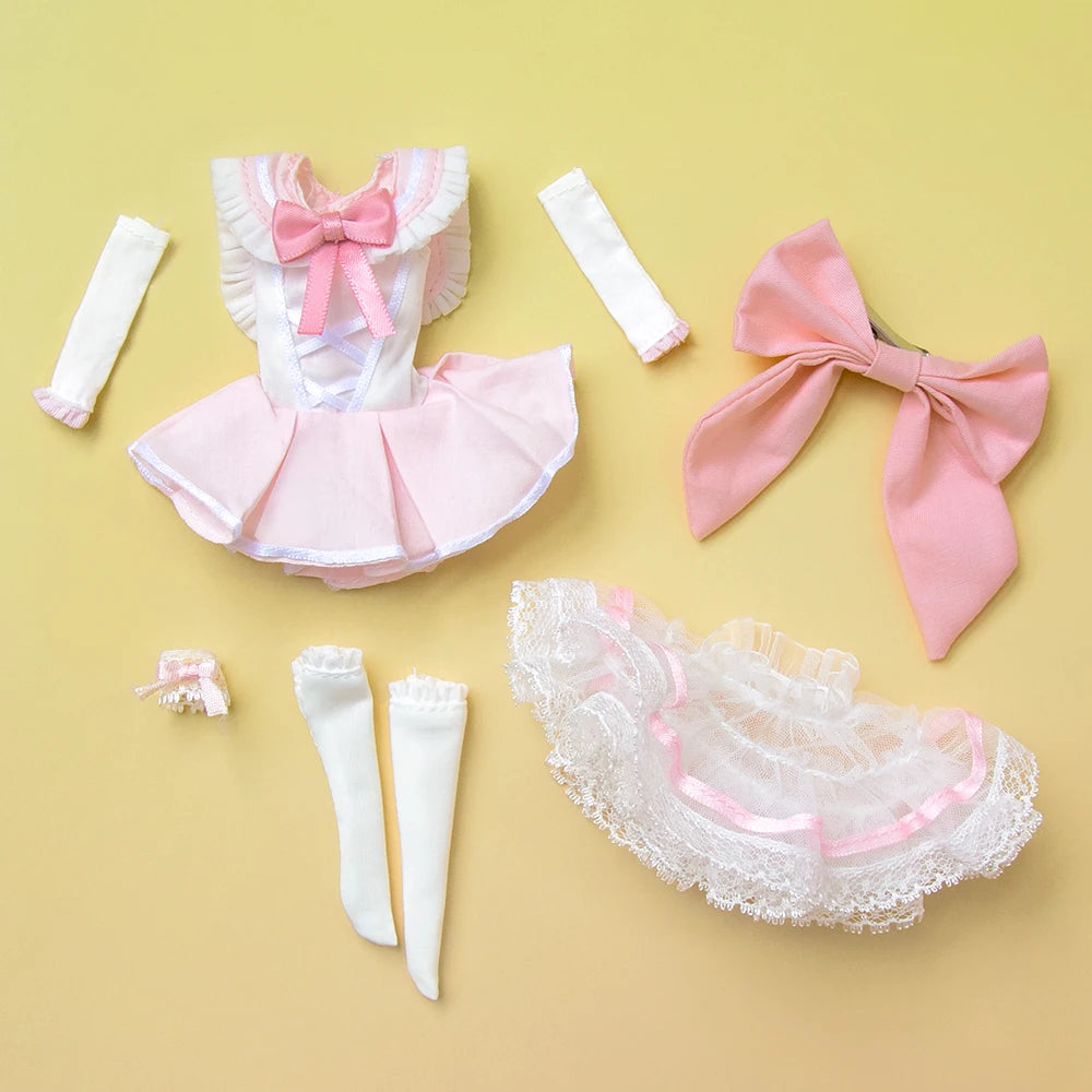 Pink and white Lolita-style doll outfit with ribbons and lace displayed on a light yellow background.