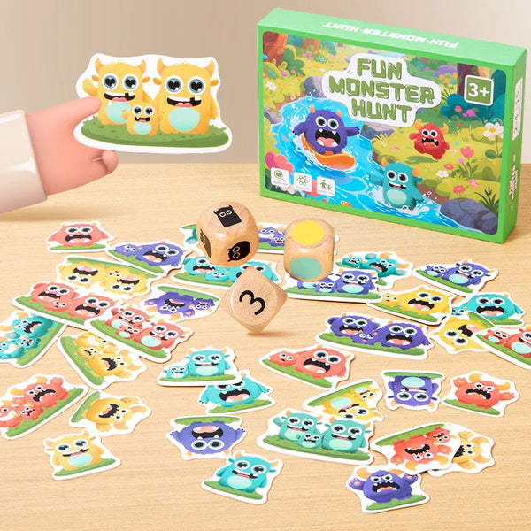 A box of a monster hunt matching game with various colorful monster shapes and pieces scattered on a wooden surface.