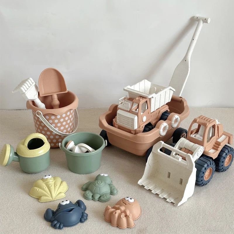 A collection of kids sand and water play toys including a pull-along bulldozer trolley, various plastic animals, and a shovel