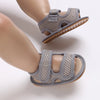 Gray breathable first walker sandals for baby with a soft sole and hook-and-loop closure
