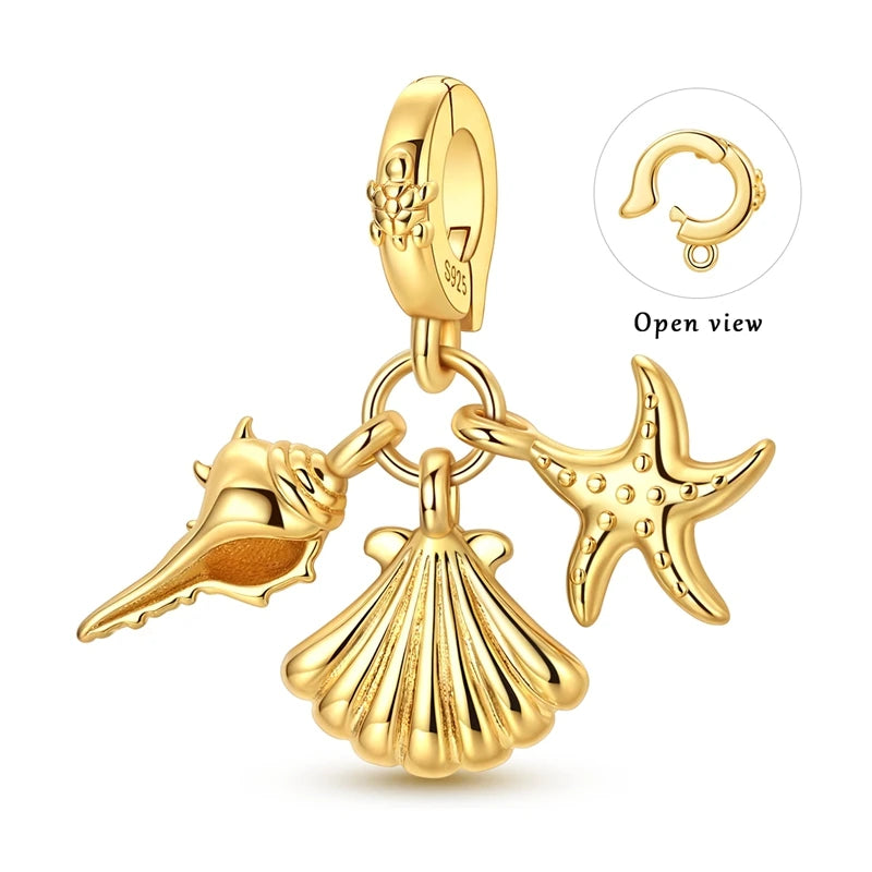 Gold-tone charm pendant set featuring a starfish, sea turtle, and whale shark, shown with an open view.
