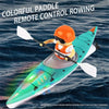 An orange-helmeted person controls a colorful paddle remote control boat on the water.