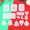 A collection of clear silicone molds shaped like snowflakes, reindeer, and Christmas trees for jewelry and craft projects.