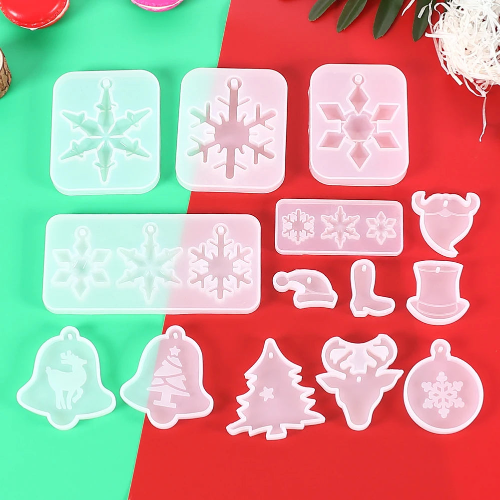 A collection of clear silicone molds shaped like snowflakes, reindeer, and Christmas trees for jewelry and craft projects.